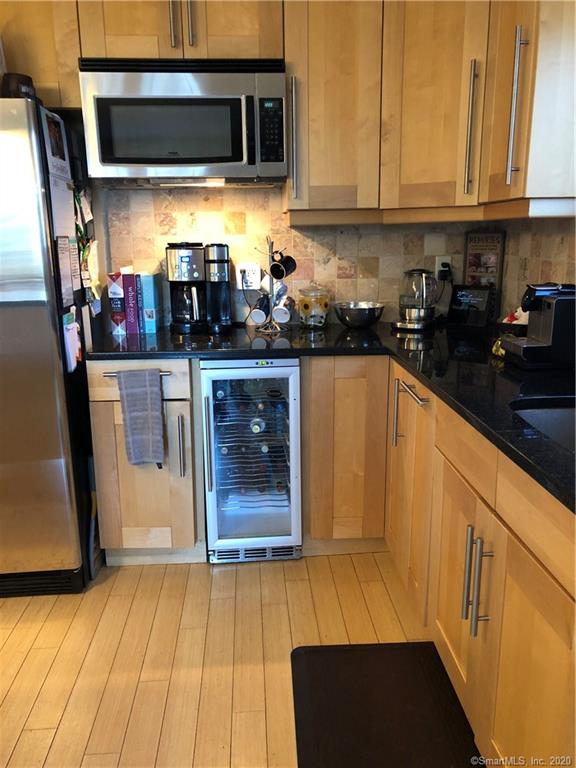 Granite counter tops, wine cooler, and microwave.